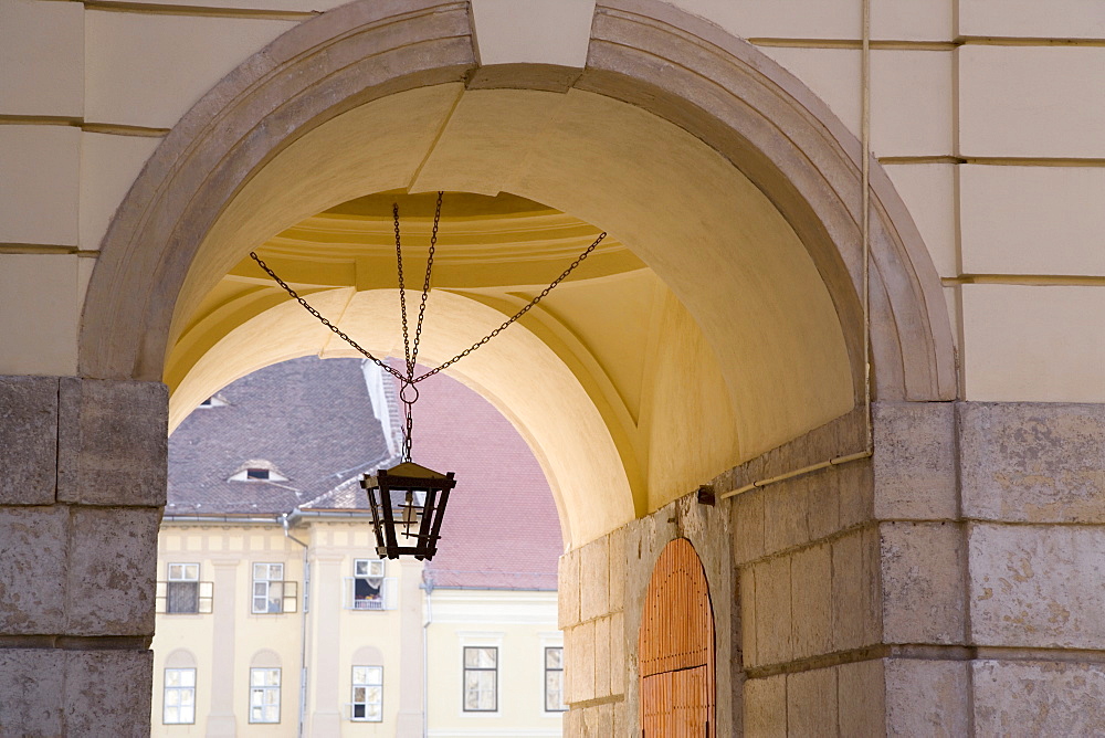 Decorative lantern hanging under an archway in the old town's main square, Piata Mare, in the 12th century Saxon city, Sibiu, Transylvania, Romania, Europe