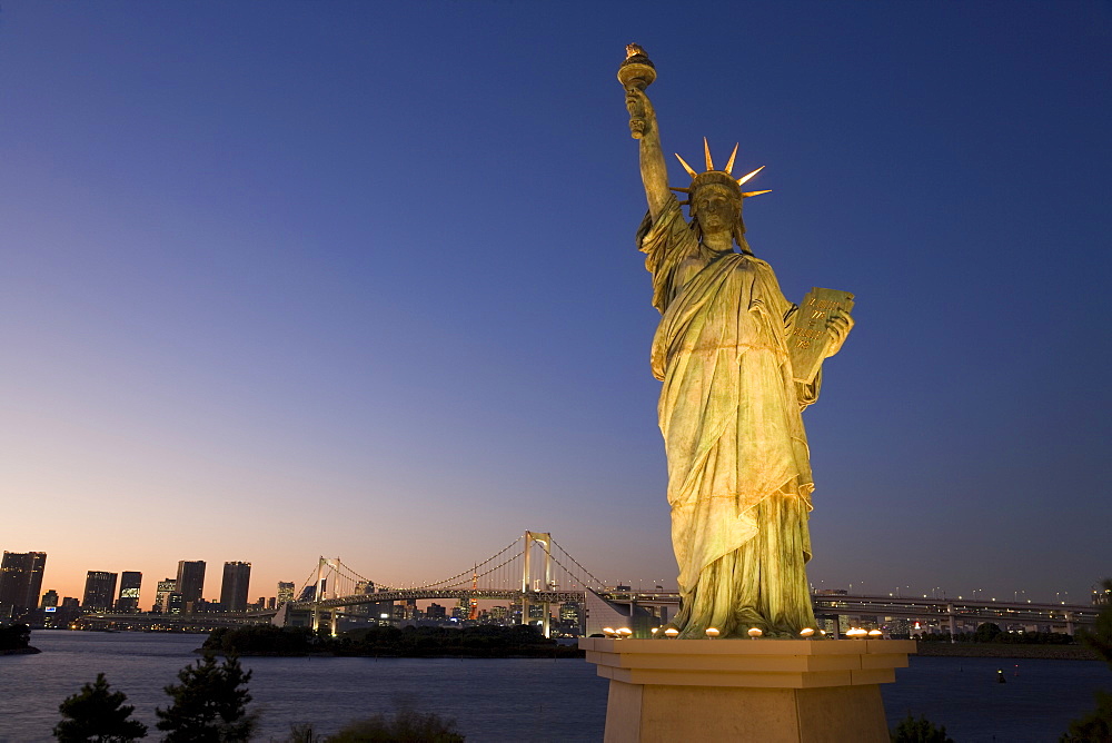 Tokyo Tower and the replica Statue of Liberty illuminated at dusk, Rainbow Bridge, Odaiba, Tokyo Bay, Tokyo, Honshu, Japan, Asia