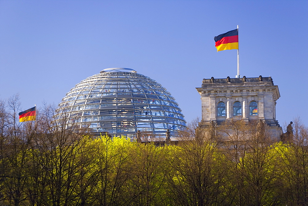 Reichstag (German Parliament building), glass dome on top and German flags, Berlin, Germany, Europe