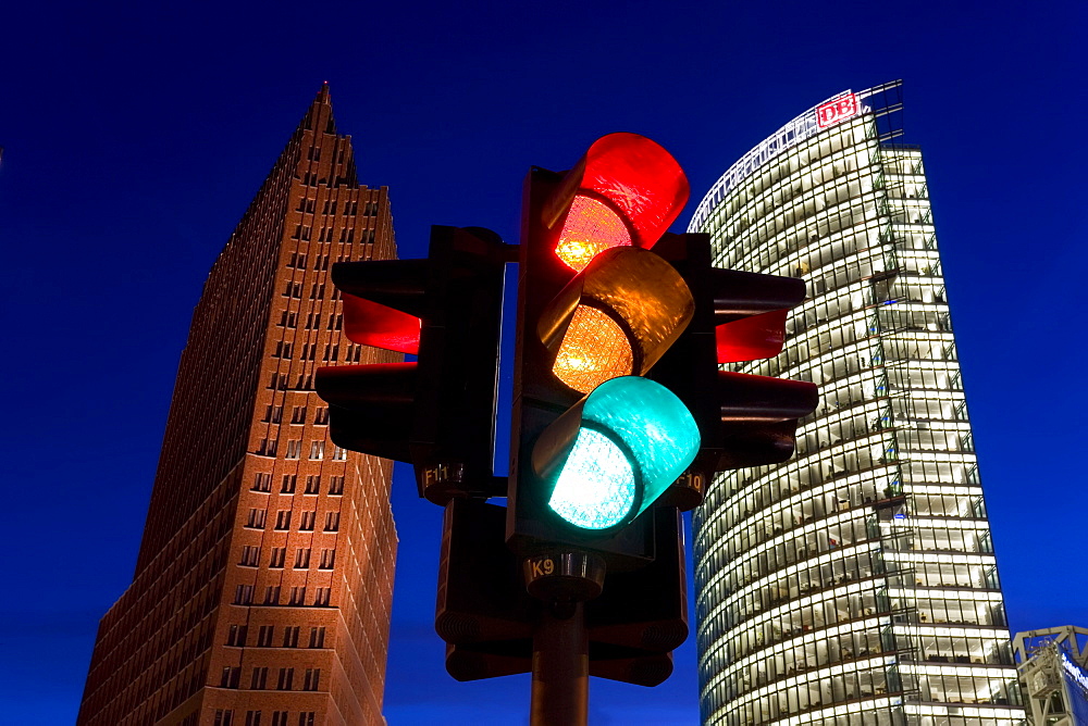 Traffic signal and office buildings illuminated at dusk in new urban development, Potsdamer Platz, Berlin, Germany, Europe