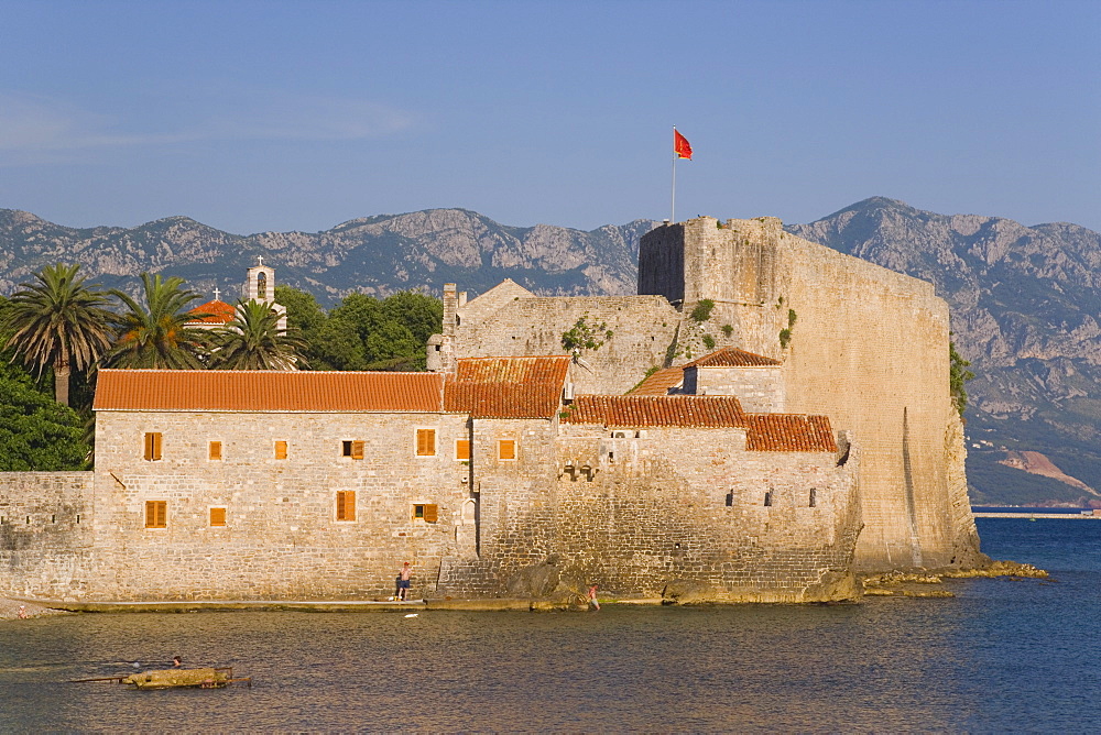 Town beach looking towards the walls of Stari Grad (Old Town), Budva, Montenegro, Balkans, Europe