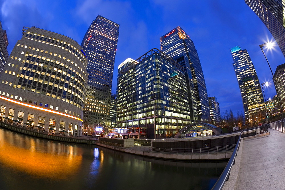 Financial District office buildings illuminated at dusk, Canary Wharf, London, England, United Kingdom, Europe