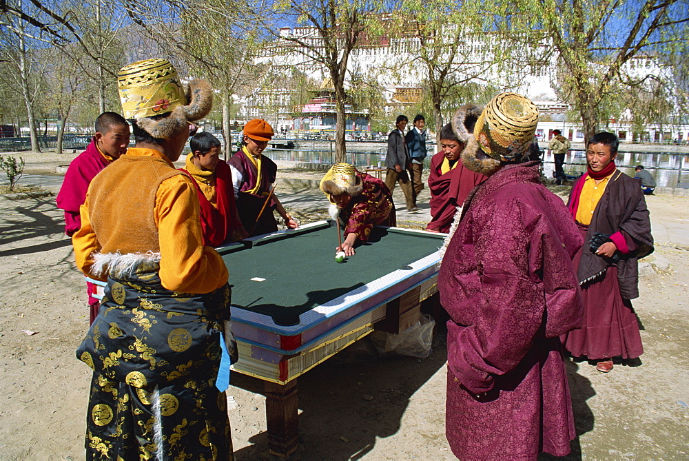 Locals playing pool with Potala Palace in background, Lhasa, Tibet, China, Asia