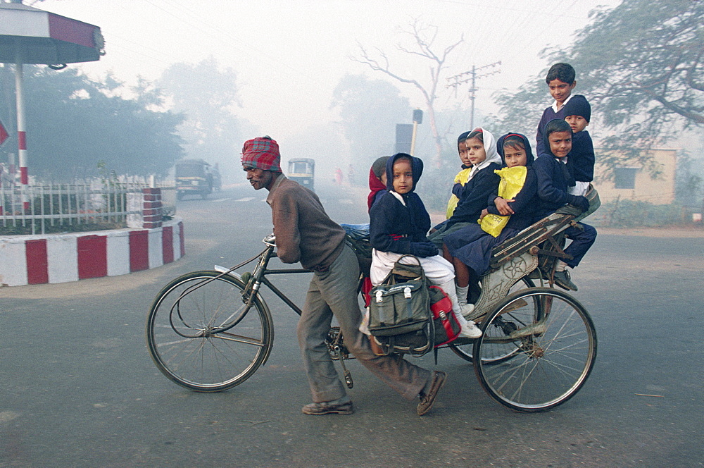 School children riding in a rickshaw in Agra, Uttar Pradesh state, India, Asia