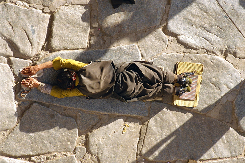 Pilgrim prostrating, Jokhang Temple, Barkhor, Lhasa, Tibet, China, Asia