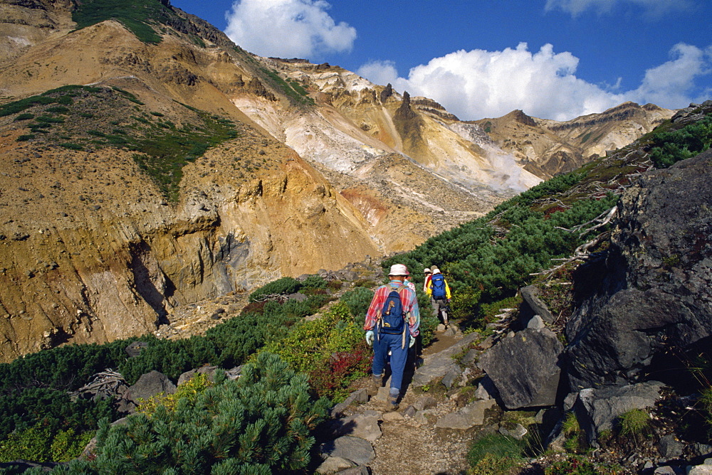 A group of hikers on a path in the Daisetsuzan Range on the island of Hokkaido, Japan, Asia