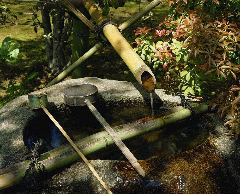 Water fountain in the grounds of a temple in Kyoto, Japan, Asia