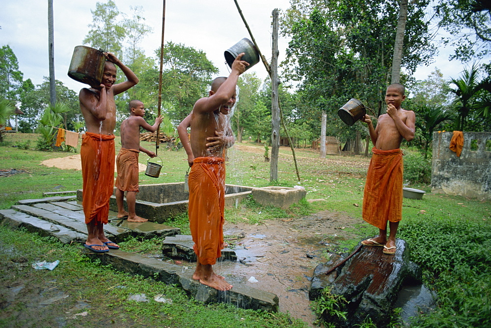 Novice monks washing in the evening near Roulos Temple, Angkor Wat, Siem Reap, Cambodia, Indochina, Southeast Asia, Asia