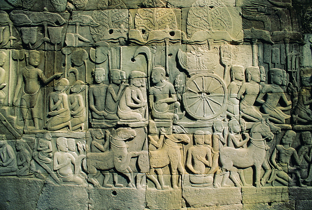 Stone bas-reliefs depicting scenes of rural life and historical events, in the Bayon Temple complex, Angkor, Siem Reap, Cambodia