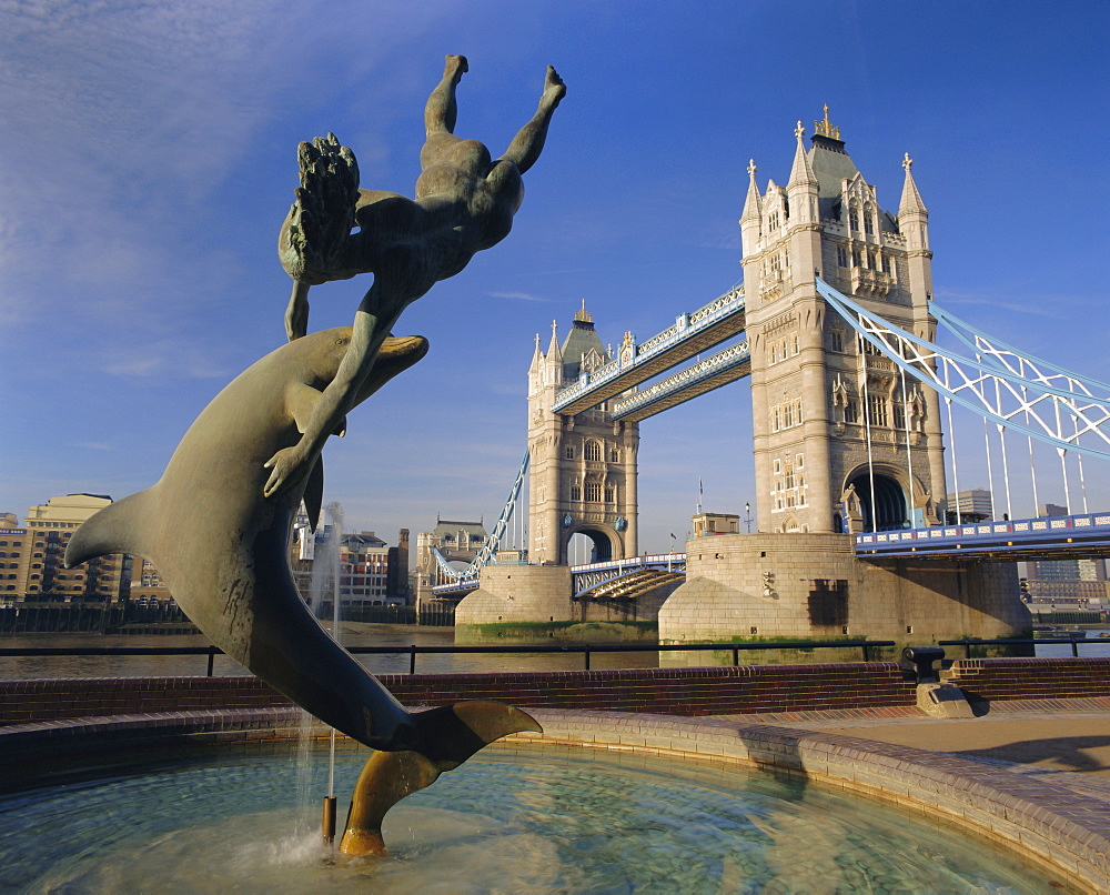 Dolphin sculpture and Tower Bridge, London, England, UK