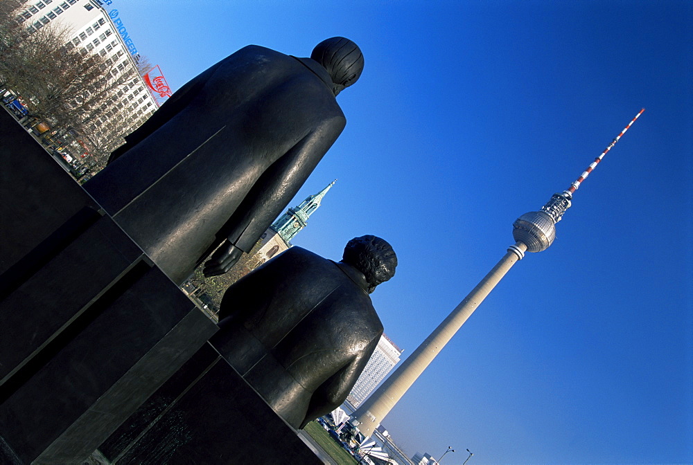 Statues of Marx and Engels, with TV Tower or Fernsehturm beyond, Berlin, Germany, Europe