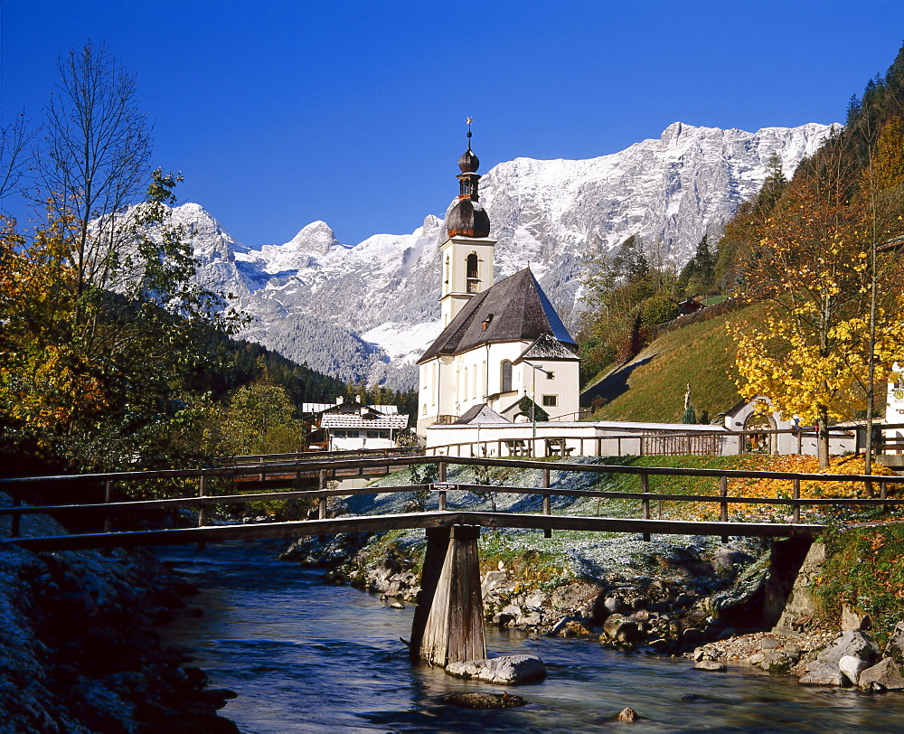 Wooden bridge in front of the church at Ramsau in the mountains of Bavaria, Germany 