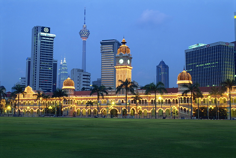 City skyline and the Sultan Abdul Samad Building illuminated at dusk, seen from Merdeka Square, Kuala Lumpur, Malaysia, Southeast Asia, Asia