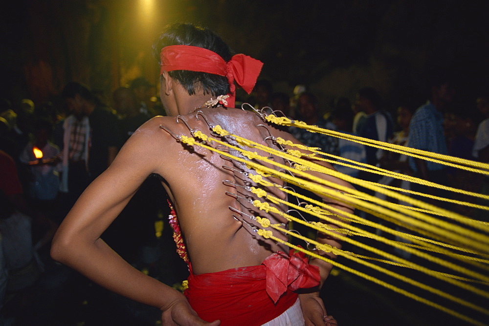 Man with hooks through the skin on his back at the annual Hindu festival of Thaipusam in the Batu Caves near Kuala Lumpur, Malaysia, Southeast Asia, Asia