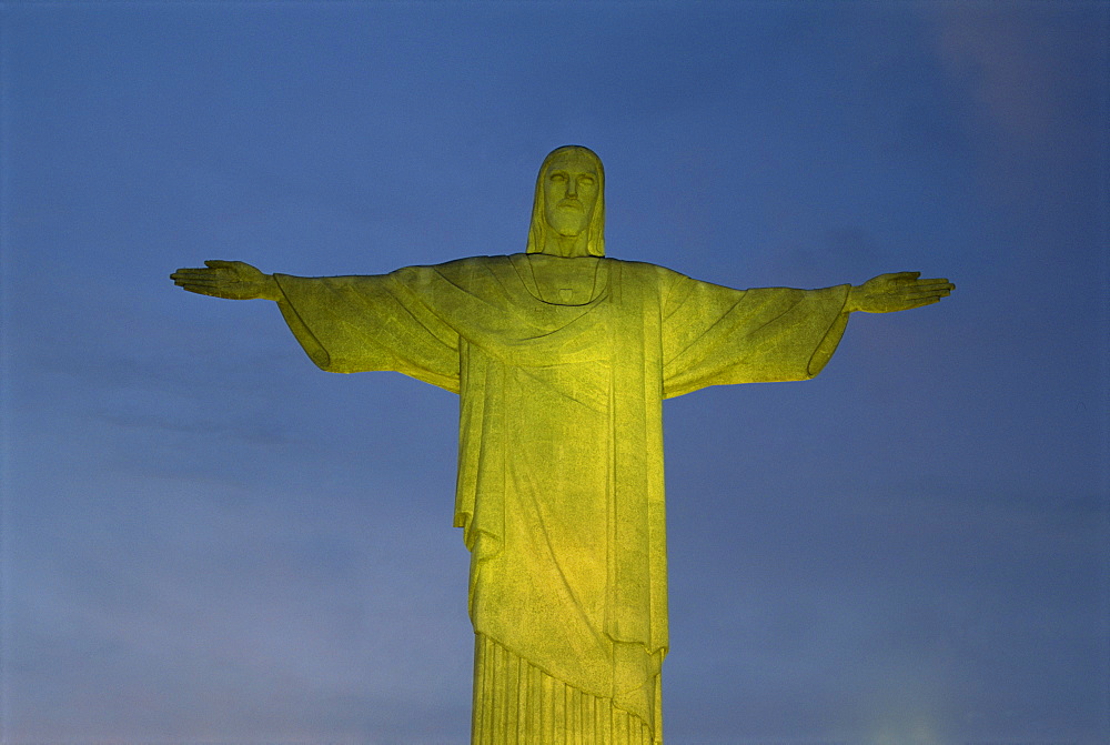 Floodlit statue of Christ the Redeemer at 710m on Mount Corcovado, above Rio de Janeiro, Brazil, South America