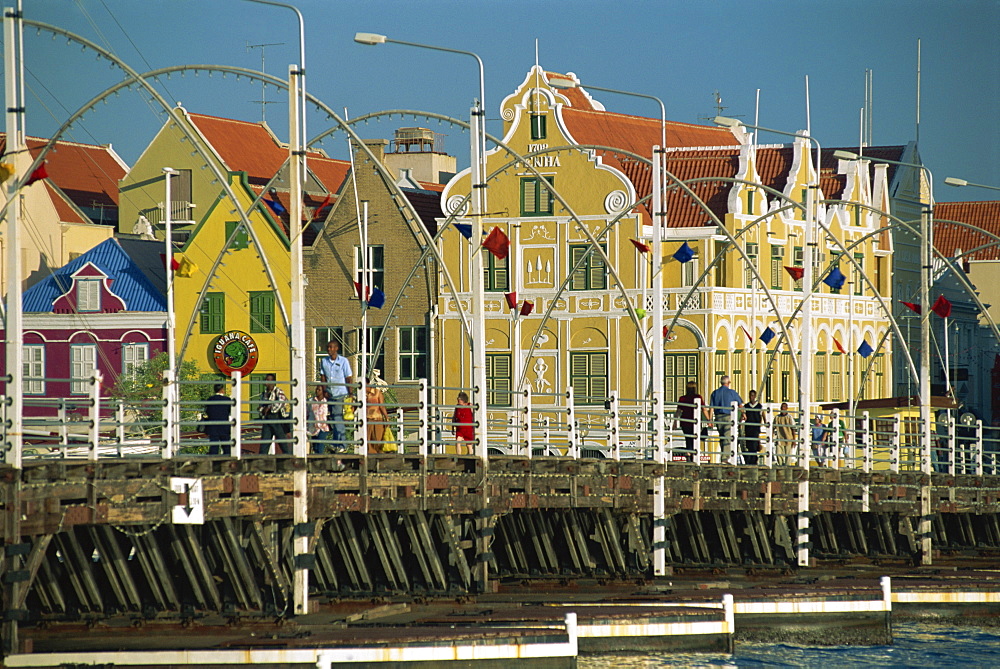 The Queen Emma Pontoon Bridge before the colonial gabled waterfront buildings of Willemstad, UNESCO World Heritage Site, Curacao, West Indies, Caribbean, Central America