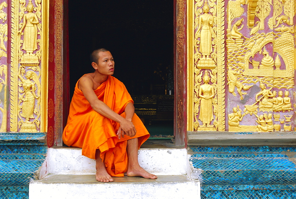 Monk in the doorway of Wat Xieng Thong, Luang Prabang, Laos