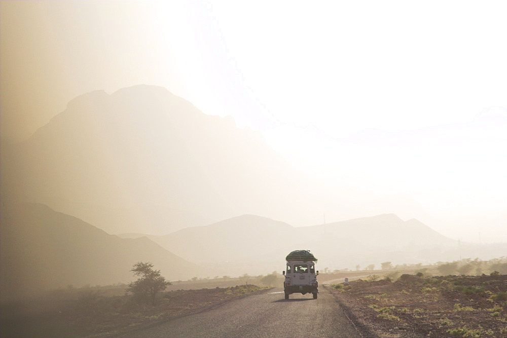 Land cruiser driving along dusty road, between Zagora and Tata, Morocco, North Africa, Africa