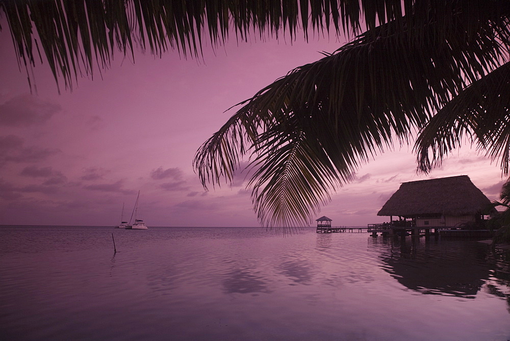 People in beach bar near the Moorings at sunset, Placencia, Belize, Central America