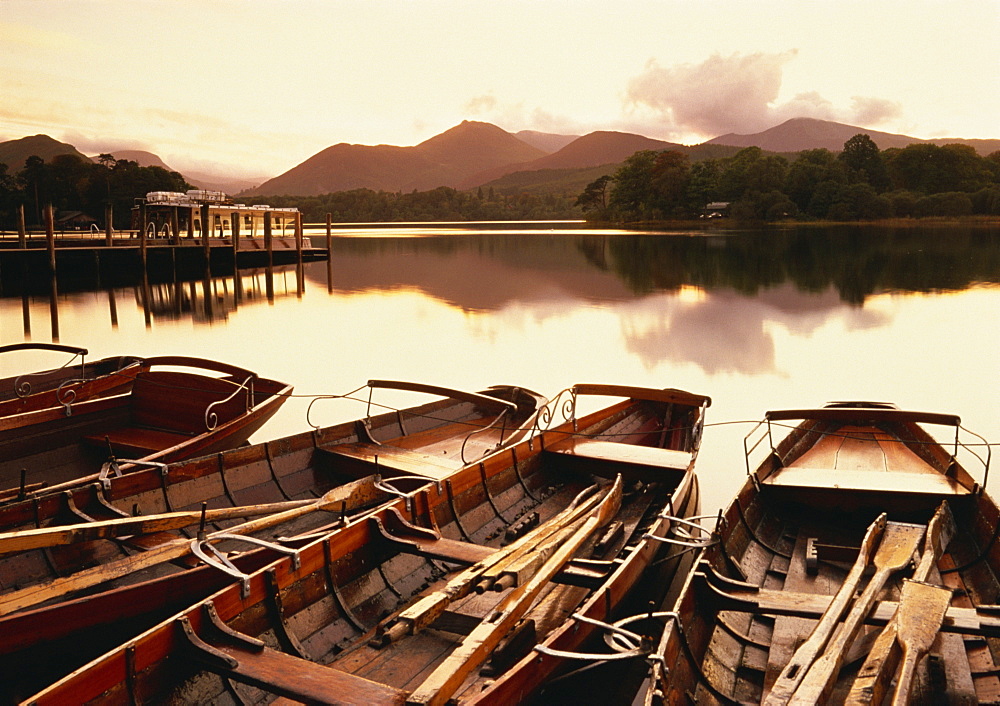 Tranquil scene at sunset over Derwentwater and Derwent Isle with pleasure boats, Keswick, Lake District National Park, Cumbria, England, United Kingdom, Europe