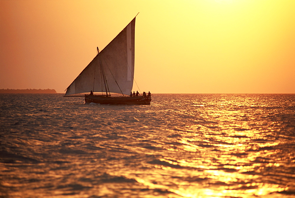 Dhow in silhouette on the Indian Ocean at sunset, off Stone Town, Zanzibar, Tanzania, East Africa, Africa