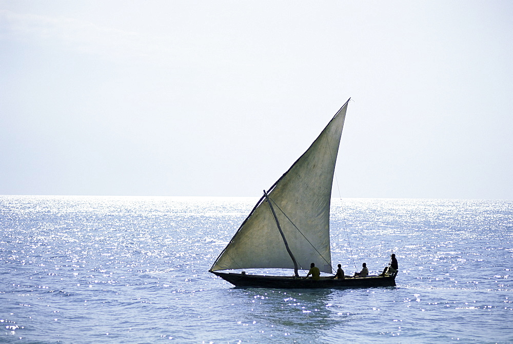 Dhow in silhouette on the Indian Ocean, off Stone Town, Zanzibar, Tanzania, East Africa, Africa