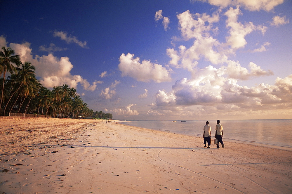 Two boys walking to school along the beach at Jambiani, Zanzibar, Tanzania, East Africa, Africa