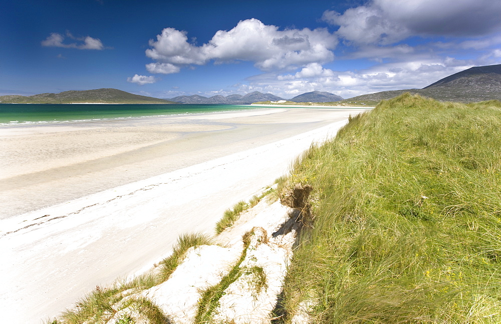 Looking across the machair to the white sand beach of Seilebost at low tide and the hills of Taransay and North Harris, from Seilebost, Isle of Harris, Outer Hebrides, Scotland, United Kingdom, Europe