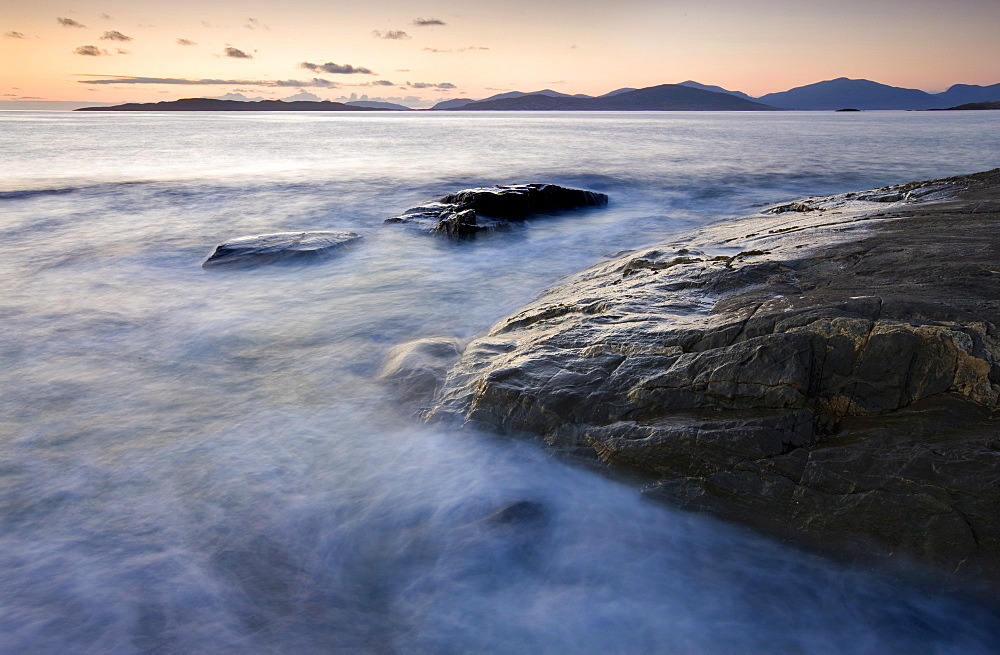 Dusk view towards Taransay and the Isle of hills of North Harris from Borve Beach, Isle of Harris, Outer Hebrides, Scotland, United Kingdom, Europe