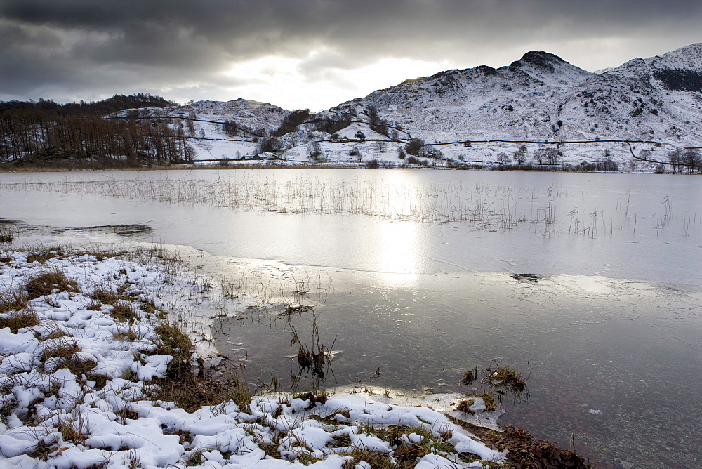 Frozen Little Langdale Tarn and snow-covered fells, near Ambleside, Lake District National Park, Cumbria, England, United Kingdom, Europe