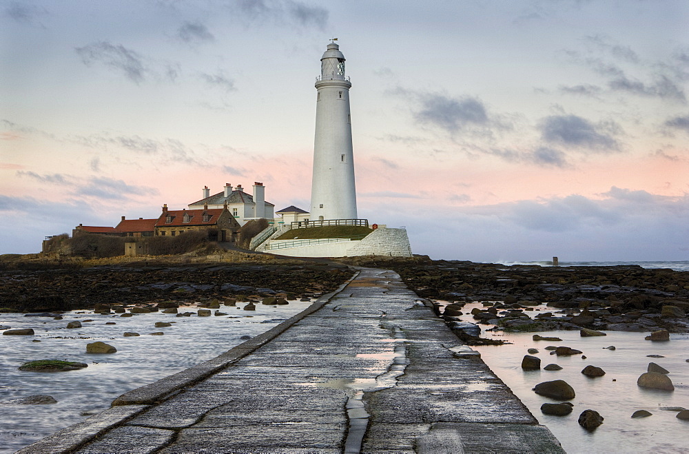 View along the tidal causeway to St. Mary's Island and St. Mary's Lighthouse at dusk, near Whitley Bay, Tyne and Wear, England, United Kingdom, Europe