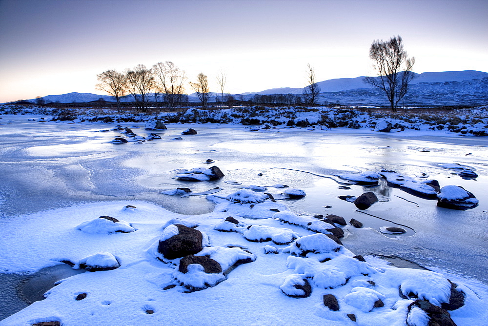 Dawn view of frozen Loch Ba on snow-covered Rannoch Moor, Highland, Scotland, United Kingdom, Europe