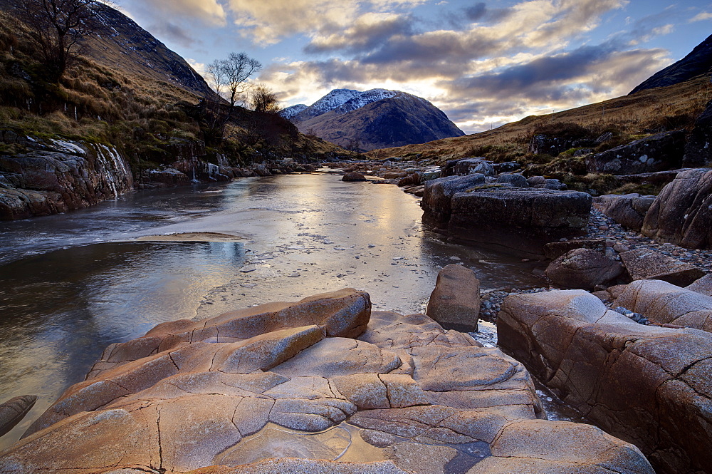 Winter view along partly-frozen River Etive towards distant mountains, Glen Etive, Rannoch Moor, near Fort William, Highland, Scotland, United Kingdom, Europe