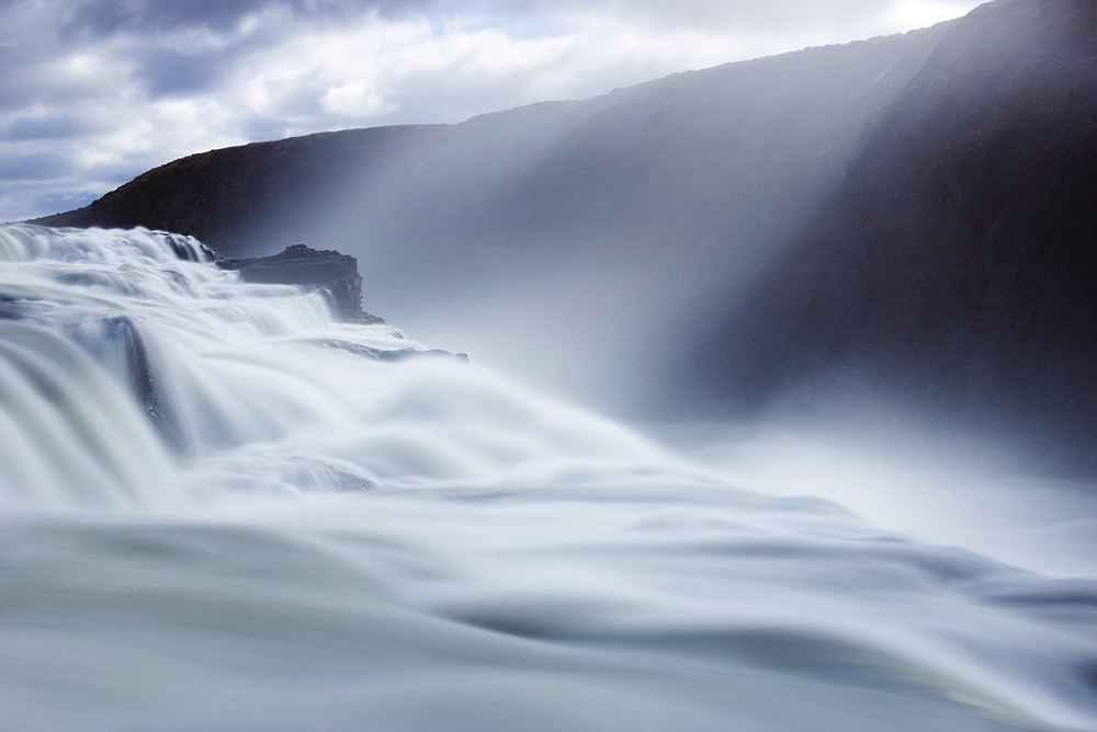 Thundering water at Gullfoss, Iceland's most famous waterfall, with sunlight streaming down through the spray, near Reykjavik, Iceland, Polar Regions