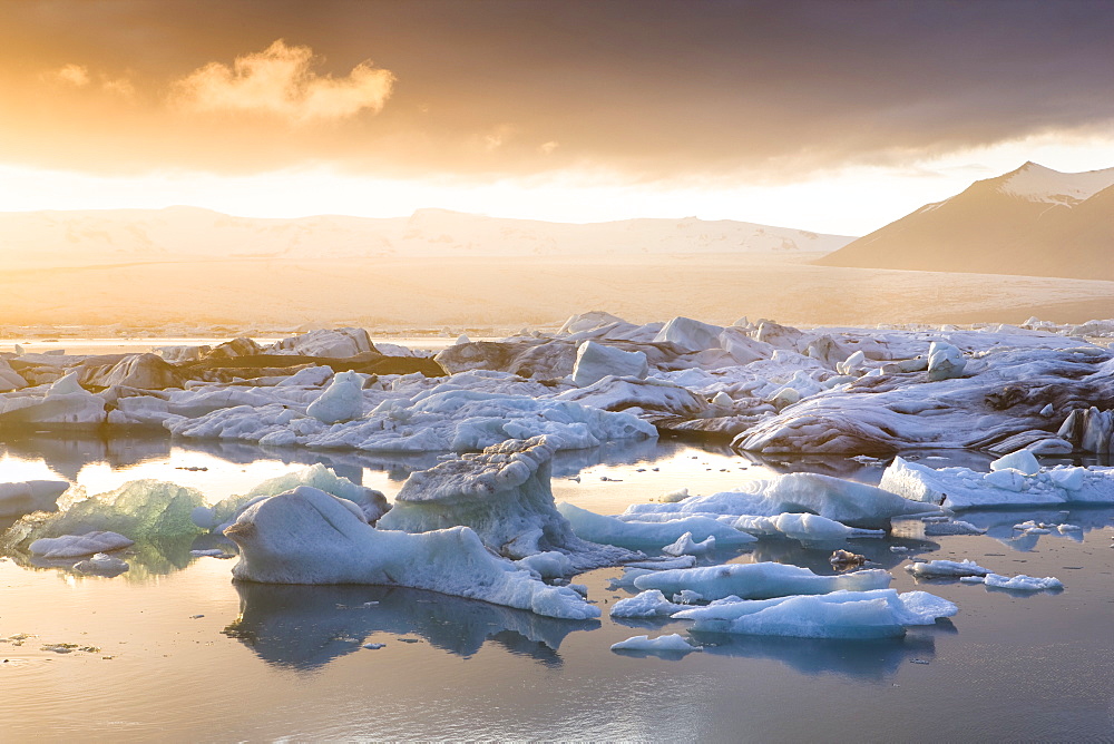 Icebergs floating on the Jokulsarlon glacial lagoon at sunset, Iceland, Polar Regions