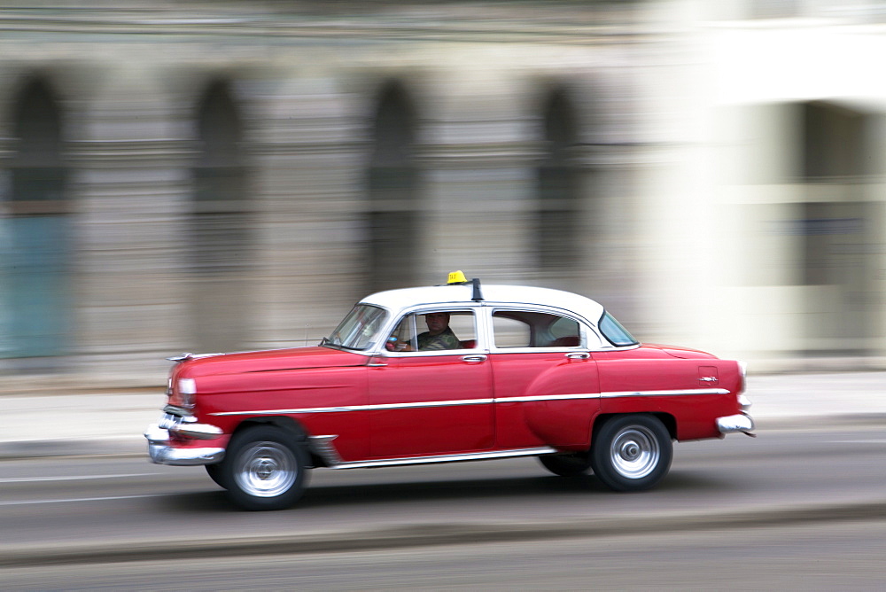 Panned shot of vintage American car on The Malecon, Havana, Cuba, West Indies, Caribbean, Central America