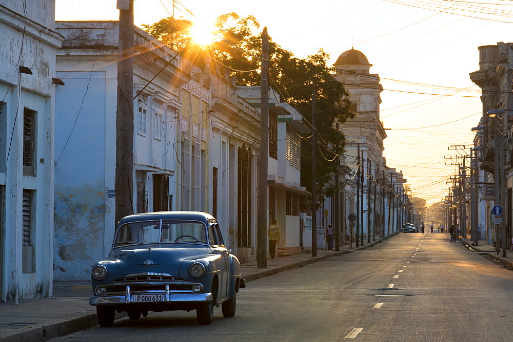 Street scene at sunrise with vintage American car, Cienfuegos, UNESCO World Heritage Site, Cuba, West Indies, Caribbean, Central America