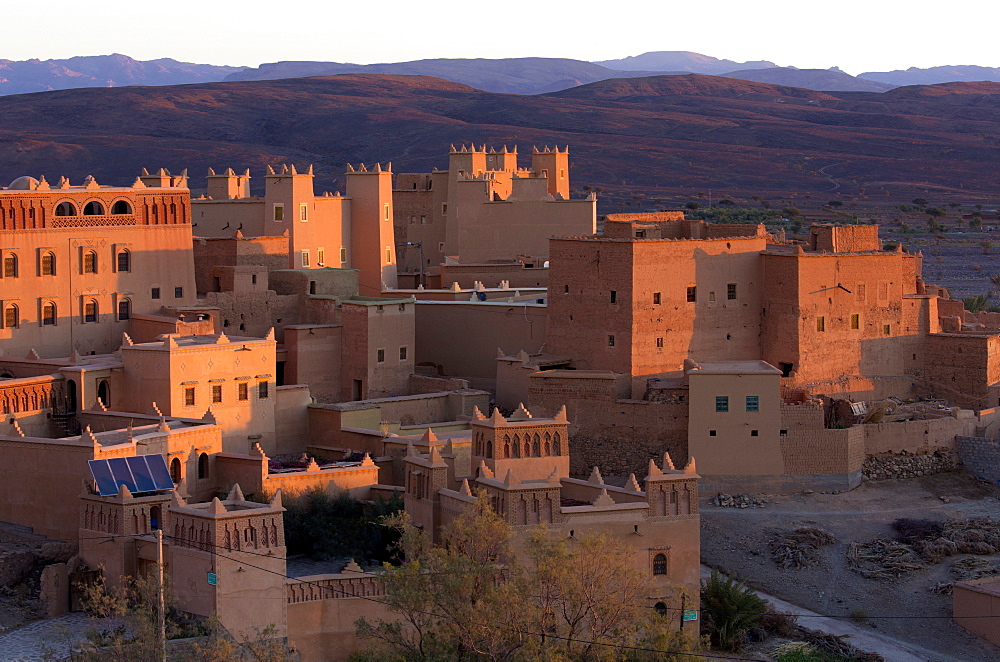 Traditional kasbahs (fortified houses) bathed in evening light in the town of Nkob, near the Jbel Sarhro mountains, Morocco, North Africa, Africa