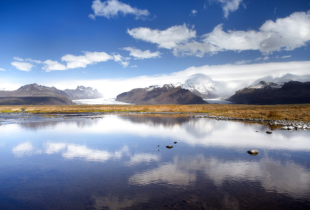 Mountains and glaciers on the edge of the Vatnajokull Ice Cap near Skaftafell National Park, reflecting in a nearby lake, South Iceland, Iceland, Polar Regions