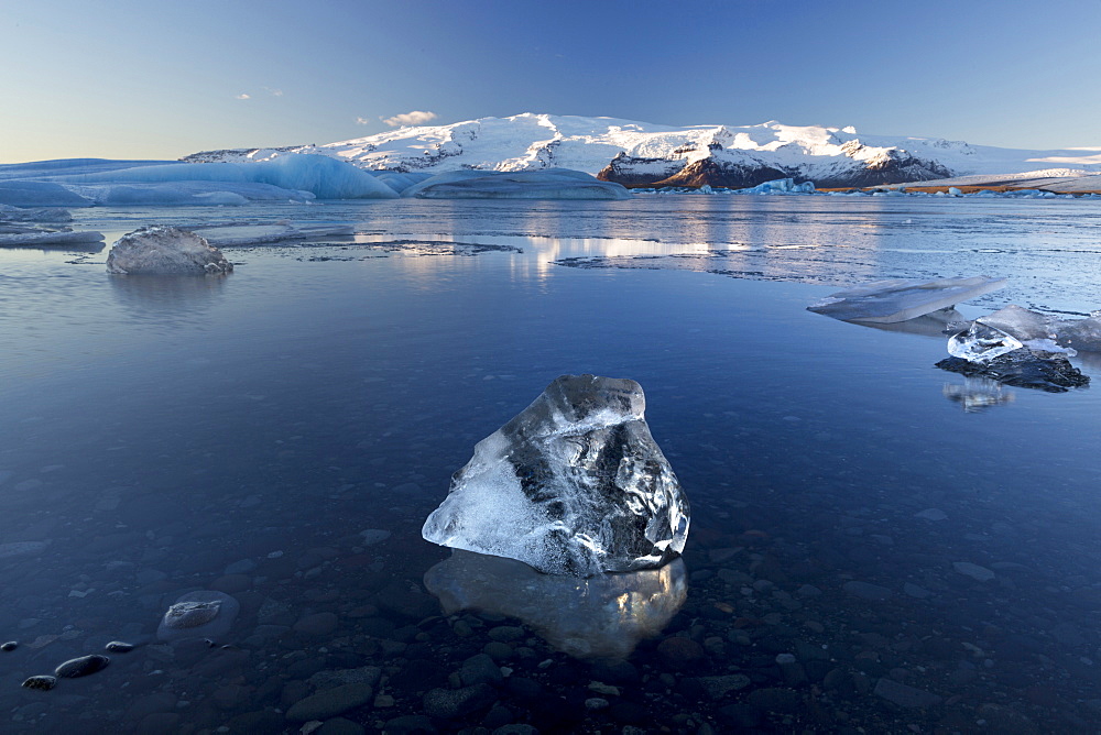 View of icebergs on Jokulsarlon, a glacial lagoon at the head of the Breidamerkurjokull Glacier, with some icebergs illuminated by the afternoon winter sun, on the edge of the Vatnajokull National Park, South Iceland, Iceland, Polar Regions