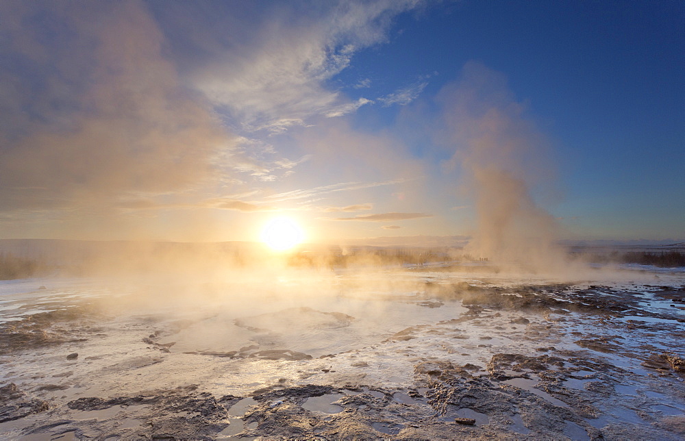 Steam rising from geothermal pools at sunrise in winter, Geysir, Haukardalur Valley, Iceland, Polar Regions