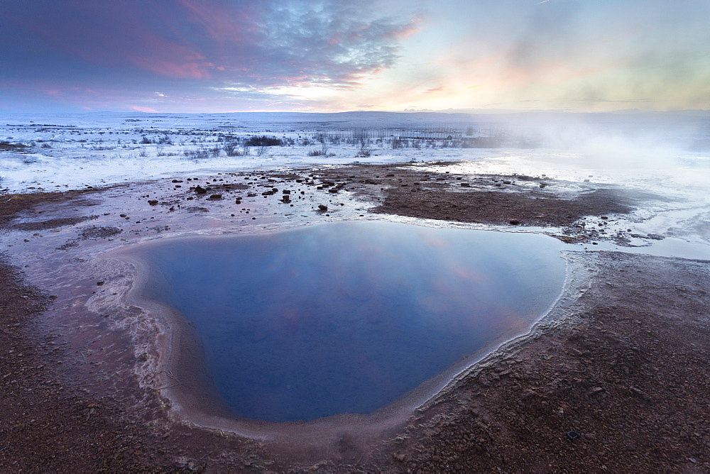 Steam rising from geothermal pools at sunrise in winter, Geysir, Haukardalur Valley, Iceland, Polar Regions