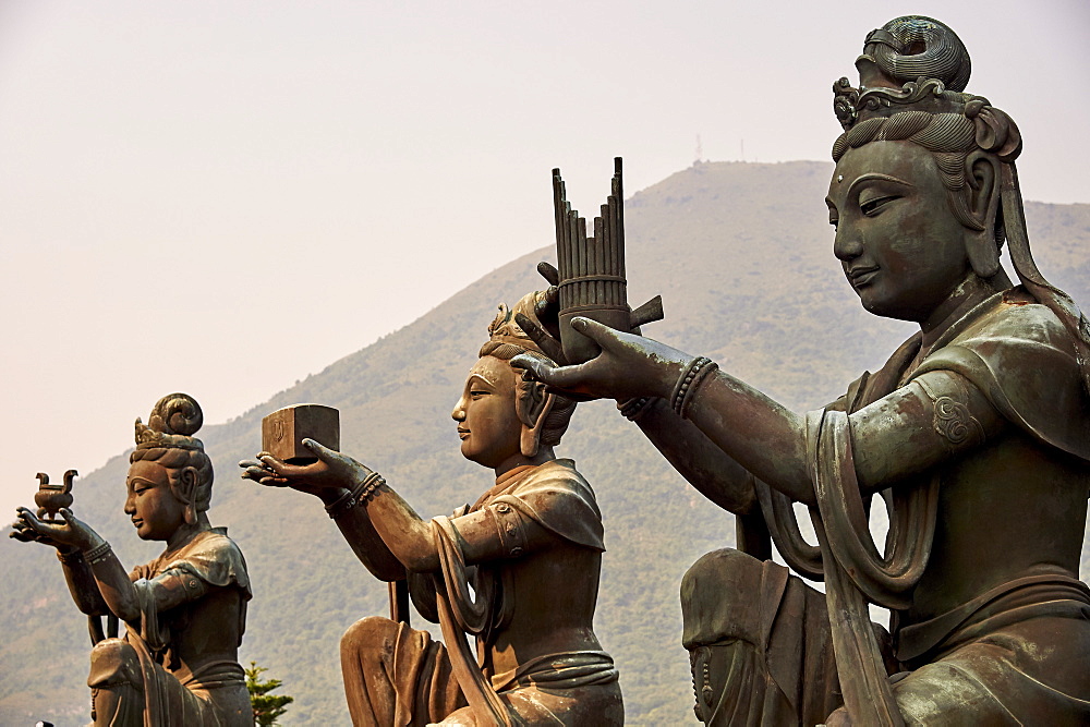 Supporting figures make offerings to Big Buddha, Po Lin Monastery, Ngong Ping, Lantau Island, Hong Kong, China, Asia