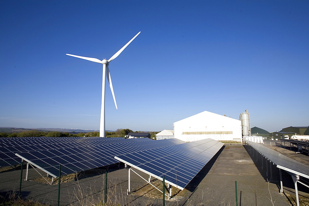 Three types of renewable electricity generation on Newton Down, wind turbine, solar panels and, in the shed, anaerobic digestion, Newton Down, Porthcawl, South Wales, United Kingdom, Europe