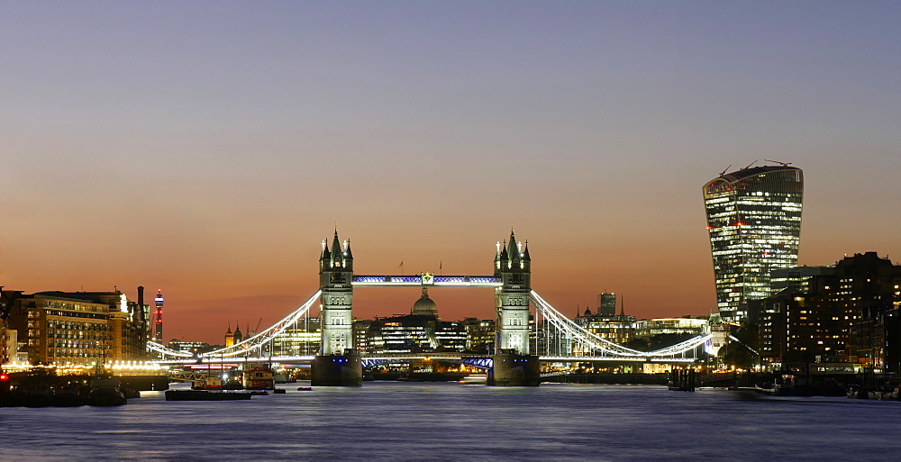 Panoramic view of Tower Bridge framing St. Paul's Cathedral with the City tower blocks at dusk, London, England, United Kingdom, Europe