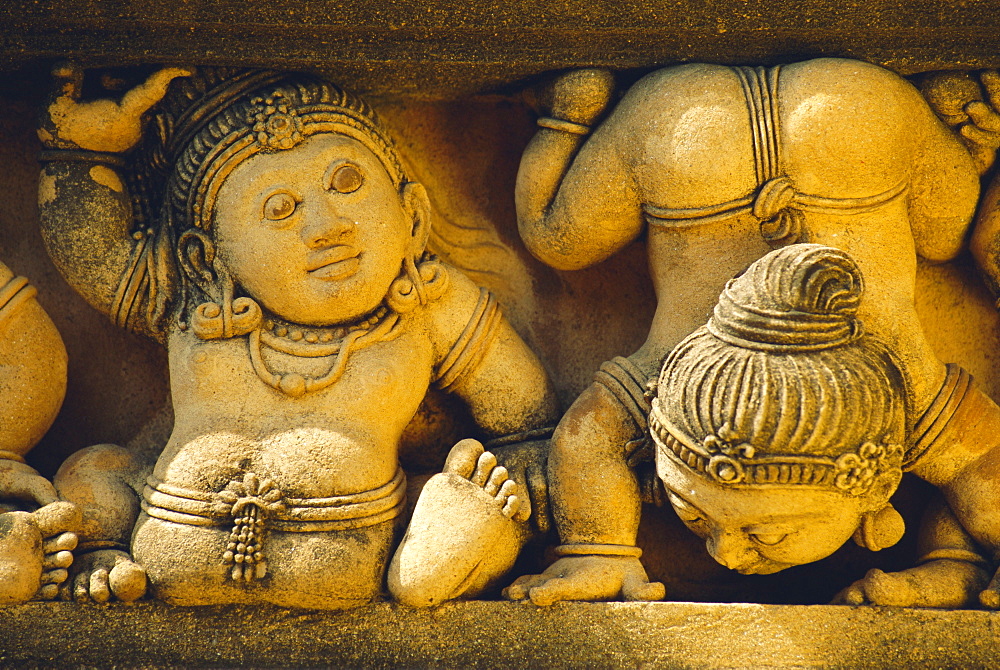 Dwarf carvings line temple wall, Kelaniya Temple, near Colombo, Sri Lanka, Asia