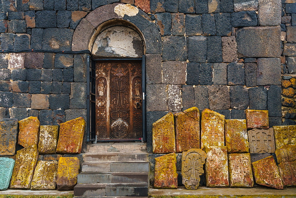 Facade of 9th century church, Sevanank Monastery, with propped up khachkars (carved memorial stones), Lake Sevan, Sevan, Armenia, Central Asia, Asia