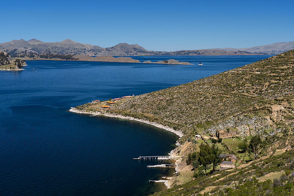 Aerial view from the top of Sun Island across deep blue Lake Titicaca to the mainland, Bolivia, South America