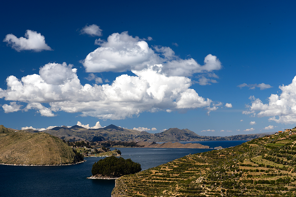 Aerial view from the top of Sun Island across deep blue Lake Titicaca to the mainland, Bolivia, South America