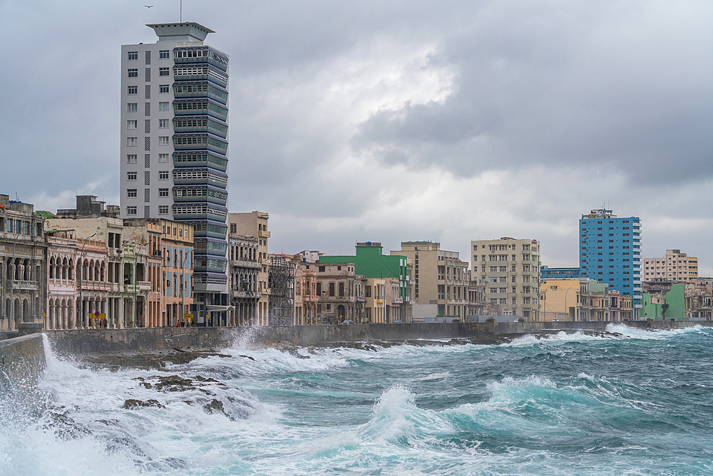 Storm waves batter the seafront Malecon with its faded grandeur stucco houses on Malecon, Havana, Cuba 2